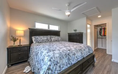 The bedroom is strategically tucked to the side of the living room, positioned away from the busy street corner.